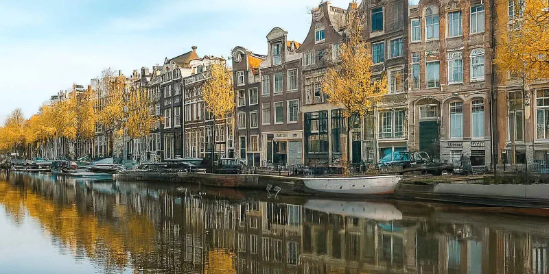Panoramic view of Amsterdam canals and houses reflecting the housing market