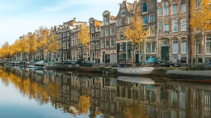 Panoramic view of Amsterdam canals and houses reflecting the housing market